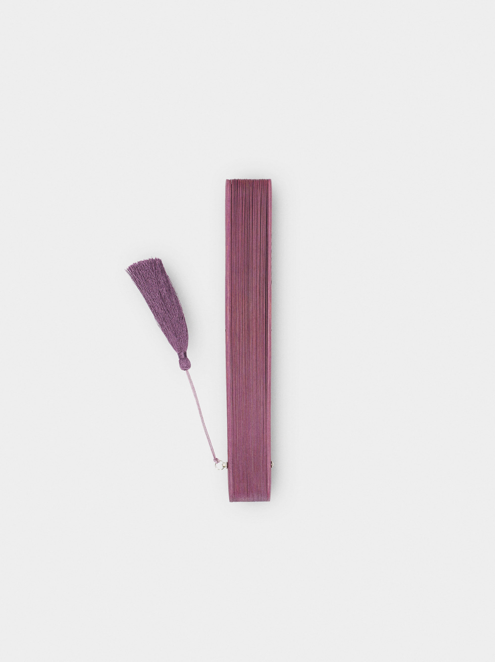 Perforated fan with tassel